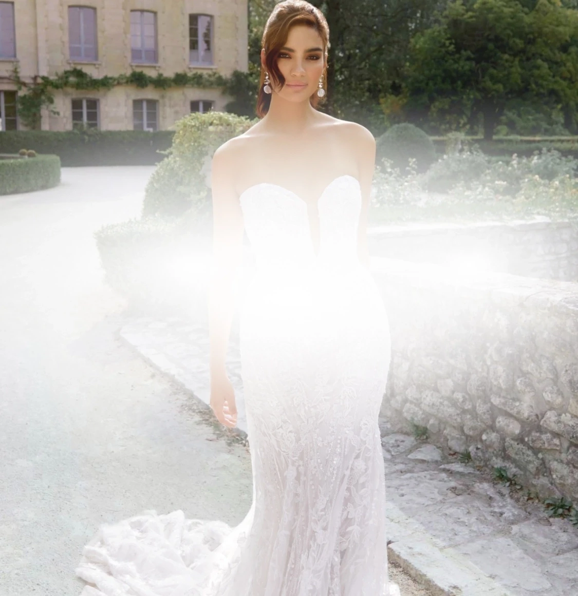 Model wearing a white gown. Mobile image