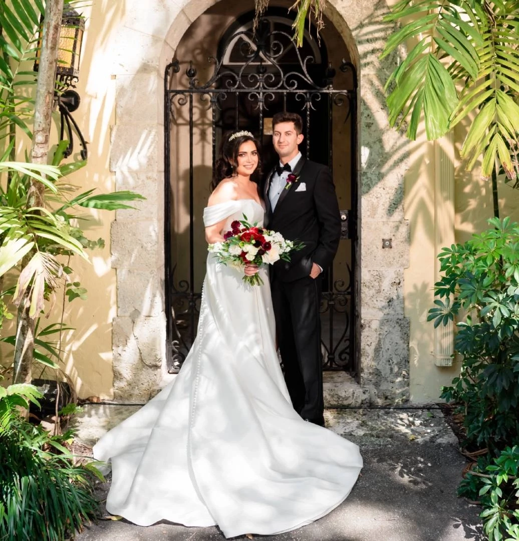 Сouple wearing a white gown and a black suit