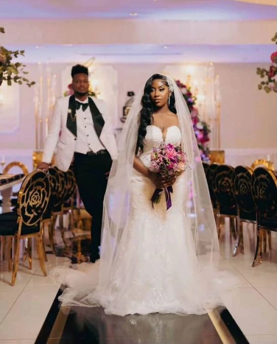 Сouple wearing a white gown and a white suit