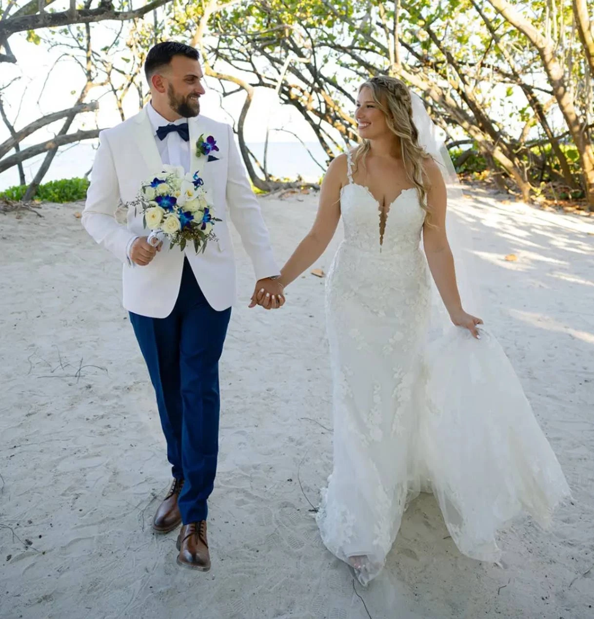 Couple wearing a white gown and a white suit